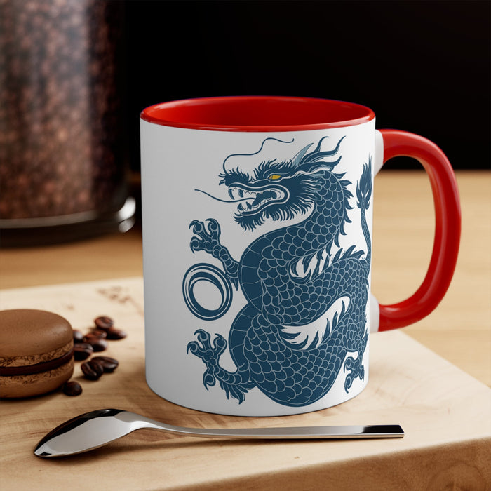 11oz accent mug with red handle and rim, blue dragon print on white body, tabletop view