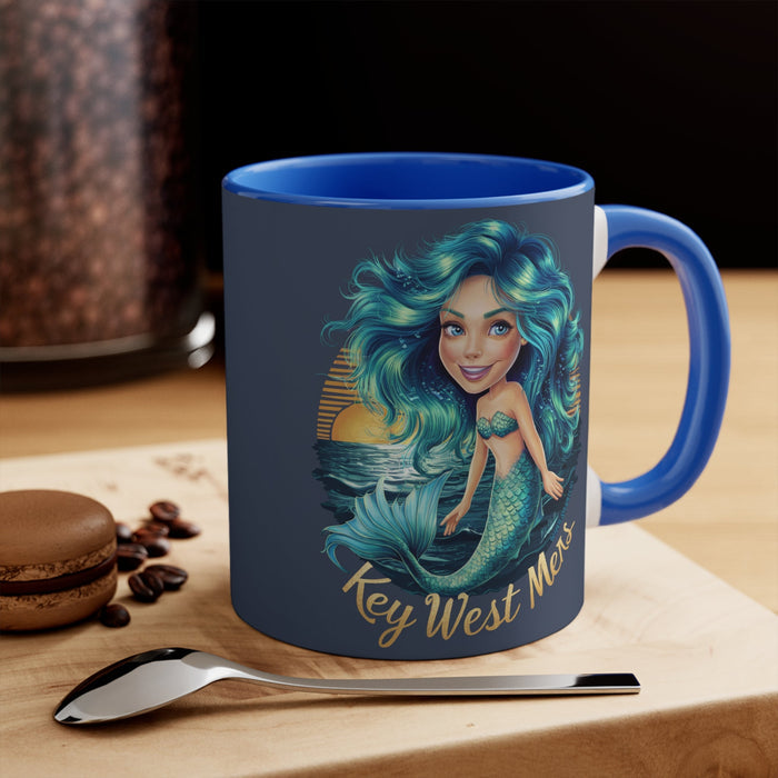 Blue accent mug with mermaid girl graphic on front, right handle and rim visible