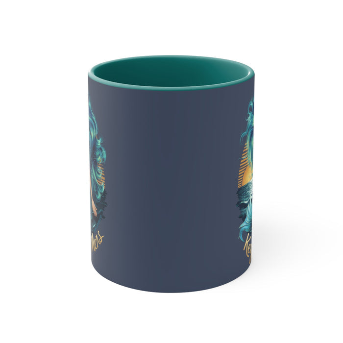 Teal accent mug showing partial mermaid artwork on side, with top rim