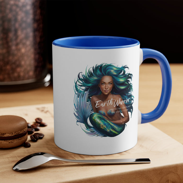 Blue-accent ceramic mug with teal-haired woman and peacock feather design, blue interior.