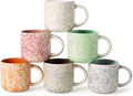 Set of six speckled ceramic coffee mugs with curved handles, assorted pastel colors