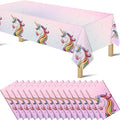 Unicorn plastic tablecloth with pink background, rainbow-maned unicorns and star dots