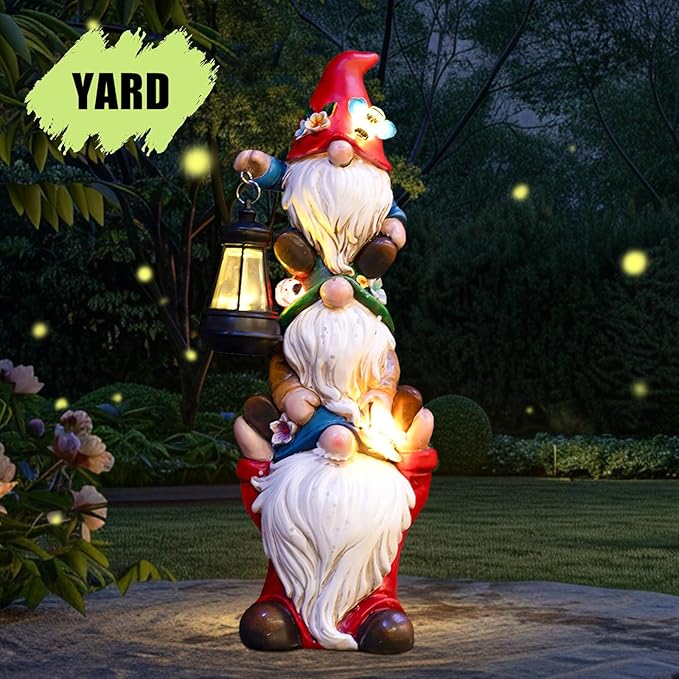 Triple outdoor garden gnome statue with red hat and glowing solar lantern on yard path