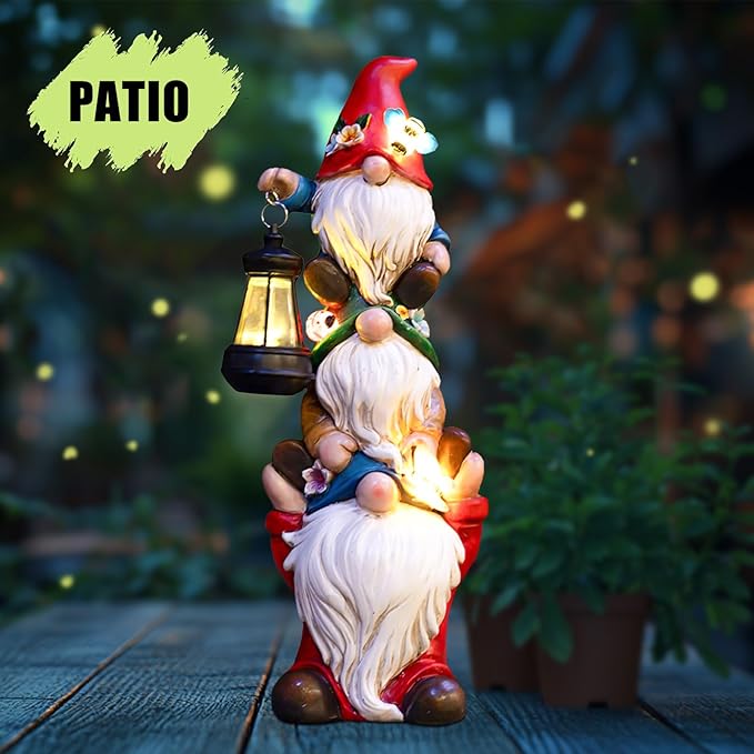 Triple outdoor garden gnome statue with red hat and warm-lit solar lantern for patio