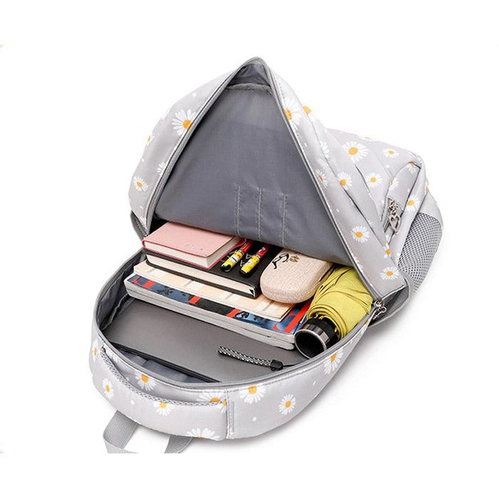 Light gray daisy school bag open with interior pockets for books and supplies