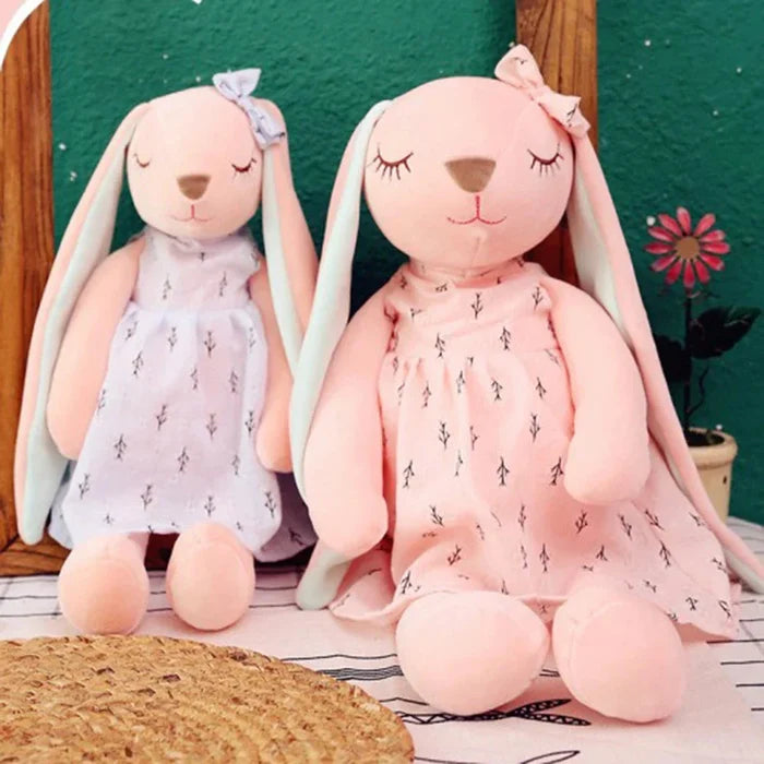Pink and blue sleeping rabbit plush toys with mint-green ears, sitting side by side