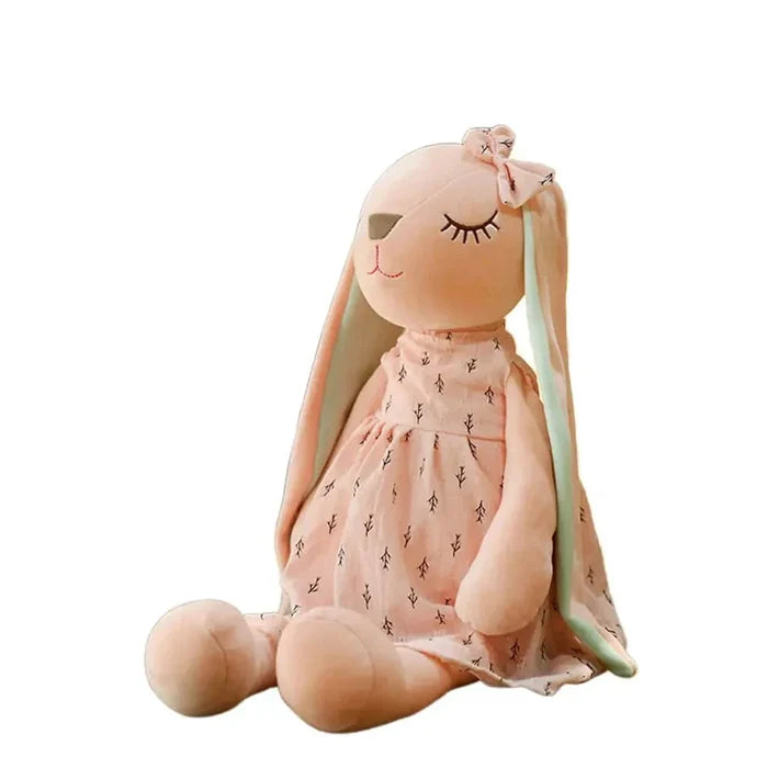 Pink sleeping rabbit plush toy with mint-green ears and a patterned dress, sitting curled