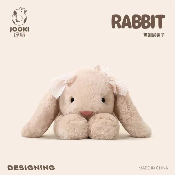 Beige plush rabbit pillow, front view with red nose and small ribbon bows on ears.