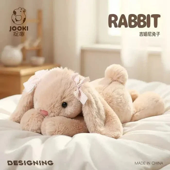 Beige plush rabbit pillow, resting pose, ribbon bow on front, plush ears up.