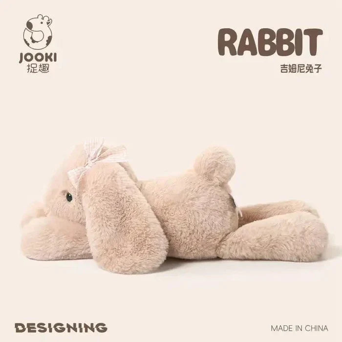 Beige plush rabbit pillow, side-lying position with long ears and ribbon bow.