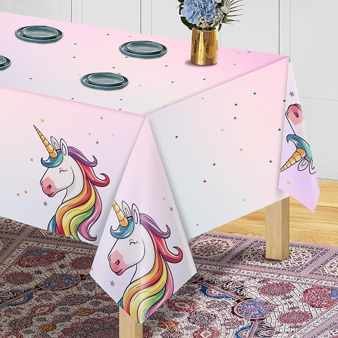 Pink unicorn tablecloth with large rainbow unicorn graphic and scattered star sprinkles