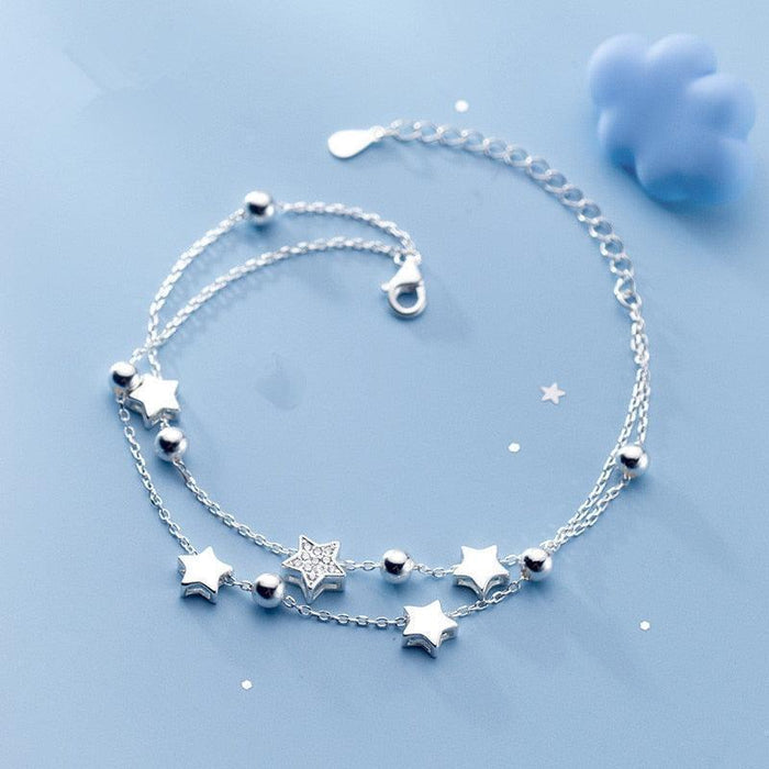 Sterling silver star charm bracelet with five-point stars and round bead accents