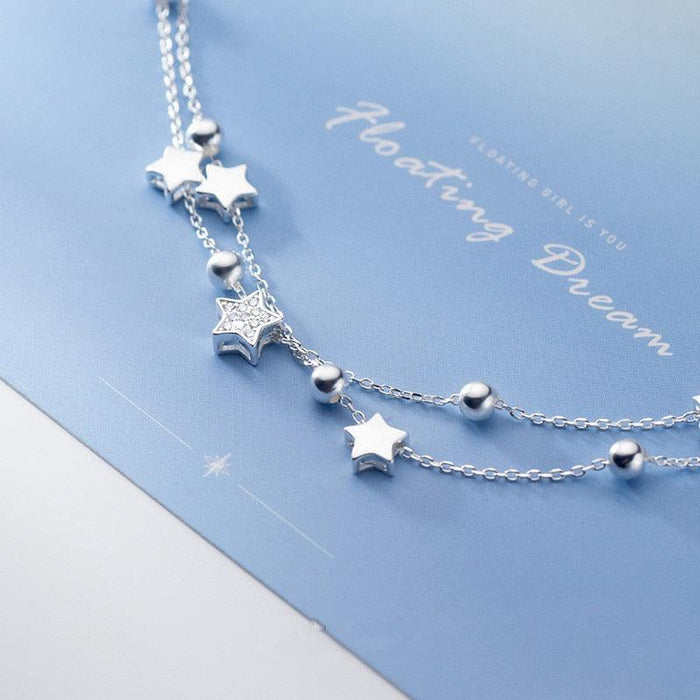 Sterling silver star charm bracelet with dangling star and bead details