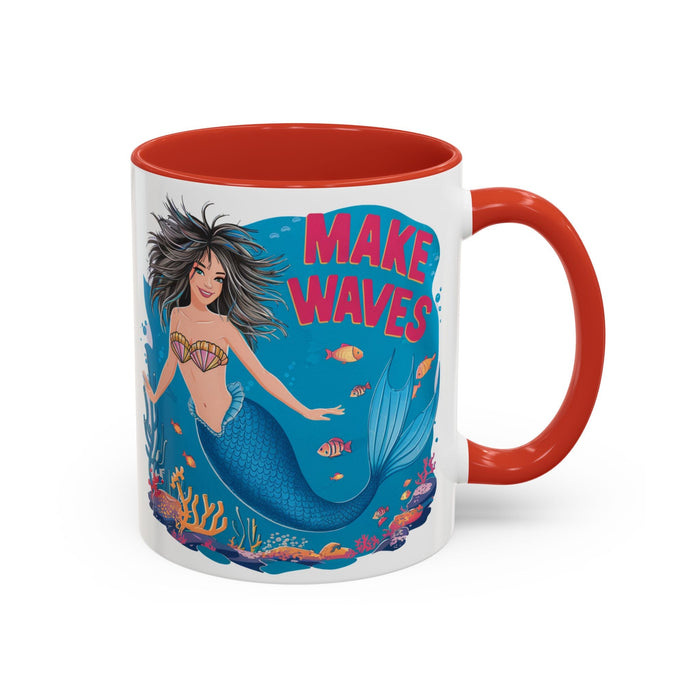 Coffee mug with orange handle and rim; mermaid "MAKE WAVES" print with coral and fish.