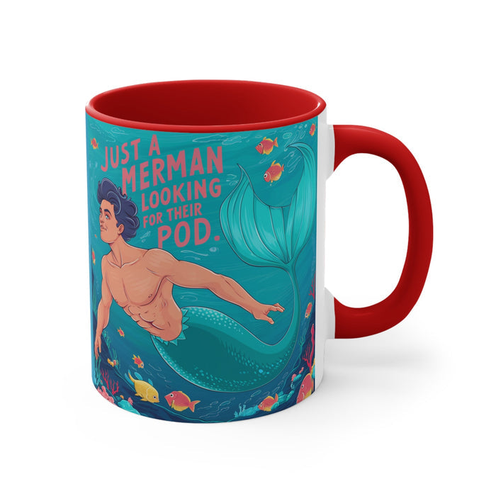 Red accent mug with teal mermaid graphic and “merman looking for their pod” lettering.