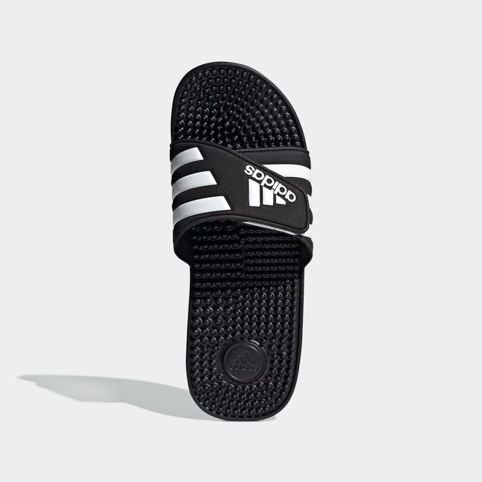 Adidas Adissage Slide sandals in black with white stripes, featuring a textured massaging footbed, top view.