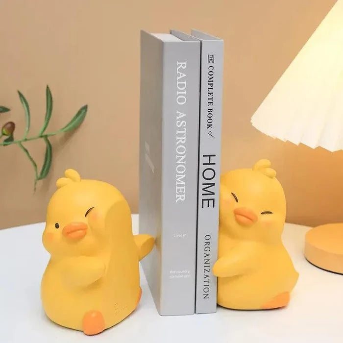 Yellow duck book ends, set of two, holding books upright