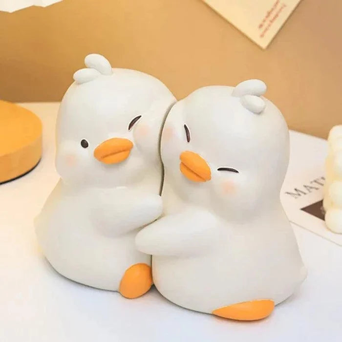 Pair of white duck book ends with orange beaks and feet