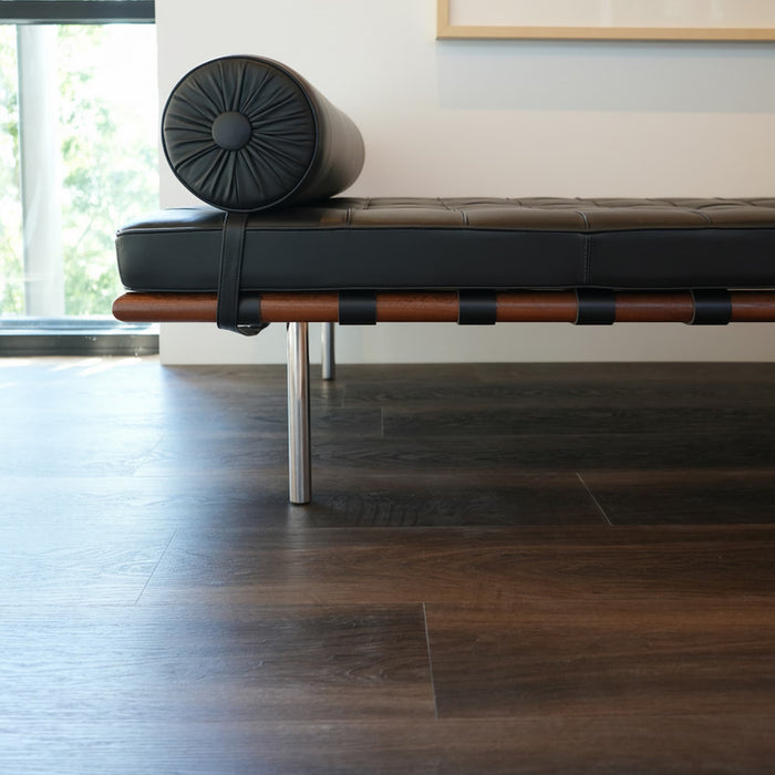 Allure buckeye black walnut lvp with modern chair and black and white photo on a white wall