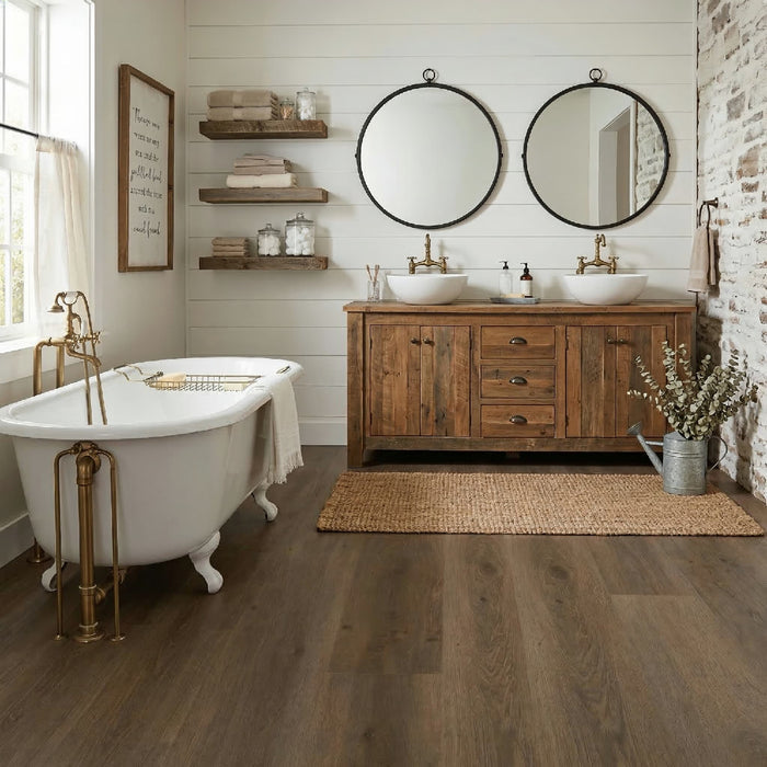 Bathroom with wooden vanity, freestanding bathtub, and round mirrors.