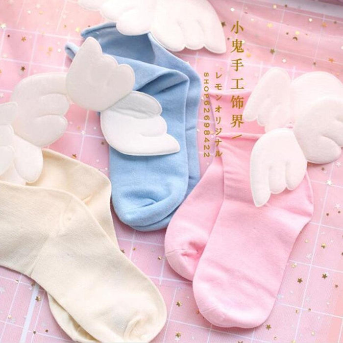 Light blue crew socks with white angel-wing appliques at the ankle
