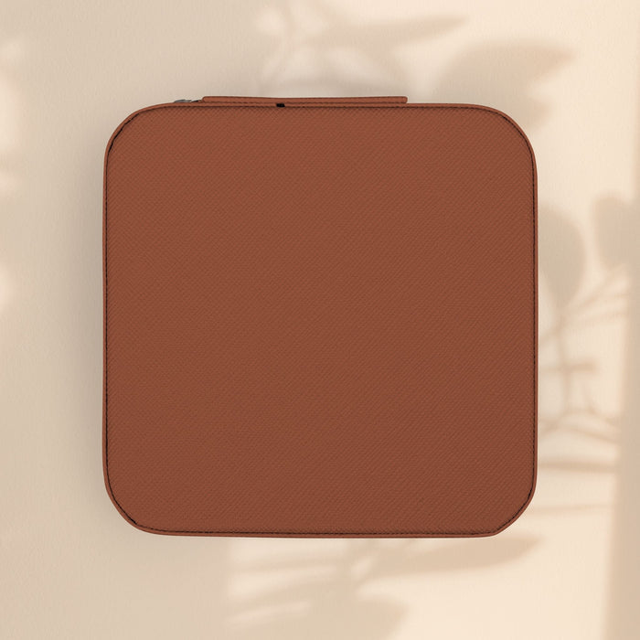 Brown zip jewelry travel case with textured exterior, compact ring and earring organizer
