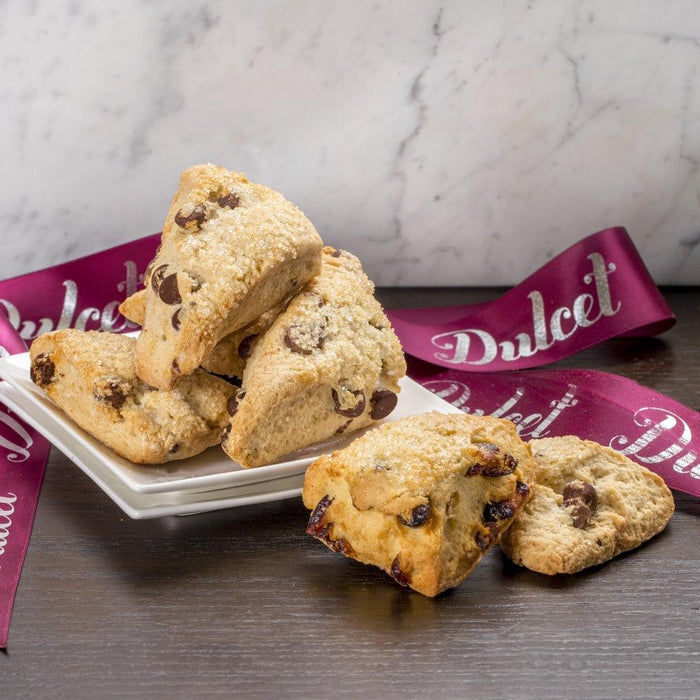 Dulcet scone assortment gift tin with crumbled scones on a plate