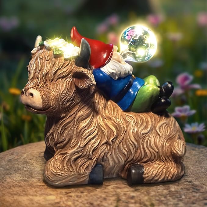 Solar highland cow gnome garden statue with red horns, blue overalls, glowing solar globe