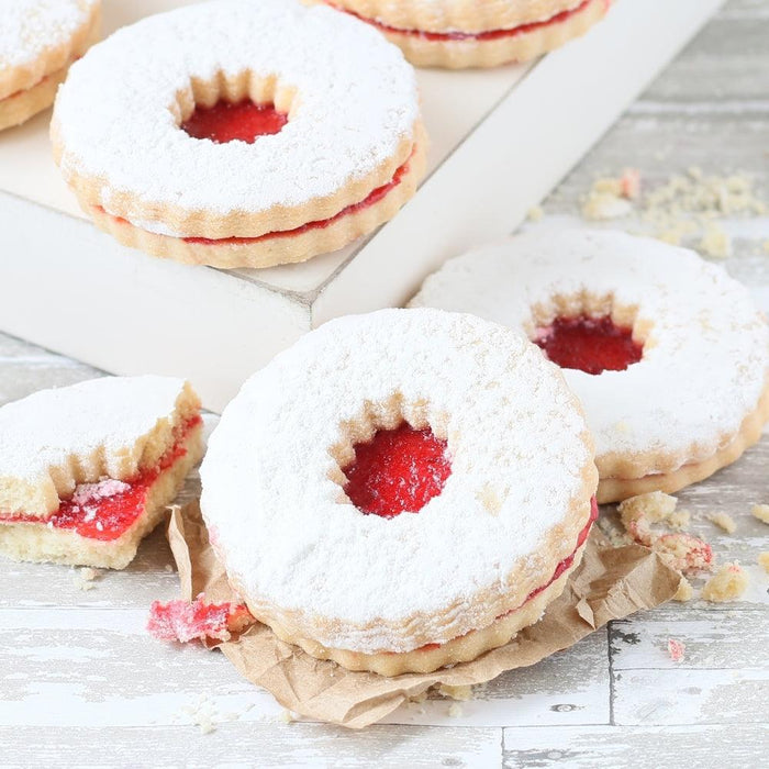 Powdered sugar Linzer-style cookies with red jam centers
