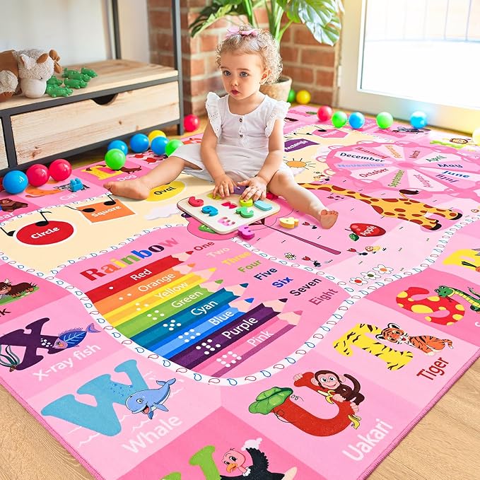 Pink children’s learning rug with rainbow number track, animals, and alphabet letters
