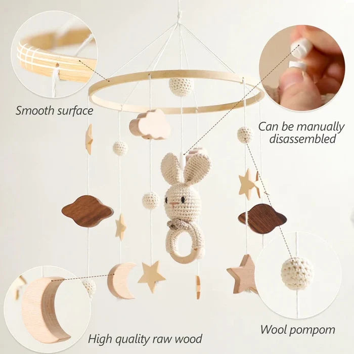 Baby bed bell mobile with smooth wood hoop and crochet rabbit with wool pom-poms