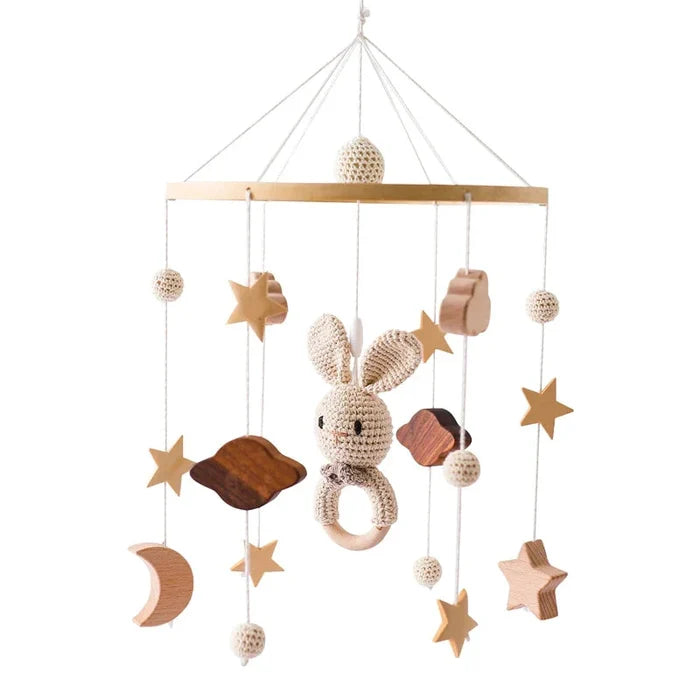 Baby bed bell mobile with crochet rabbit, stars, moon and cloud charms on wooden bar