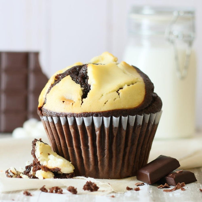 Chocolate muffin with white filling and a bit of melted chocolate