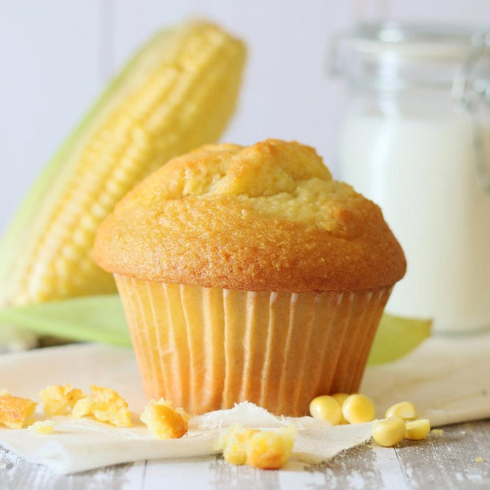 Corn muffin with crumb topping and corn kernels on the table