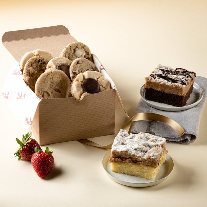 Bakery sweets gift box, open kraft box with assorted cookies and cake squares on plates