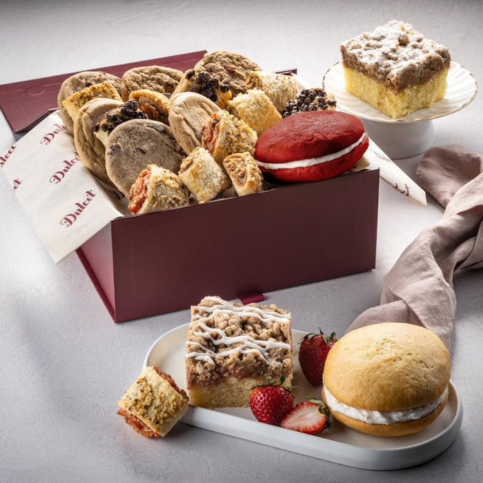 Assorted cookies and cakes in a brown bakery gift box