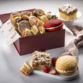 Assorted cookies and cakes in a brown bakery gift box
