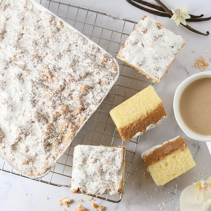 Powdered-sugar cake squares and slices on a wire cooling rack