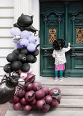 Black, pink, and purple Halloween balloon garland cluster with bat and spider shapes