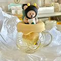 Glass tea infuser mug with bear topper and honey-yellow lid, clear side handle