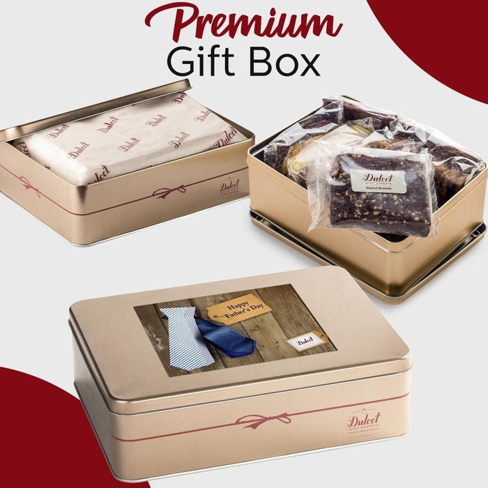 Premium gift box set with open tin showing wrapped treats and another closed tin