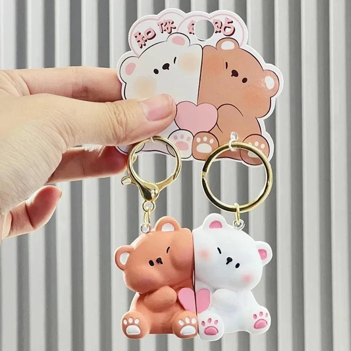 Magnetic bear keychain pair held up: brown and white figures with gold rings