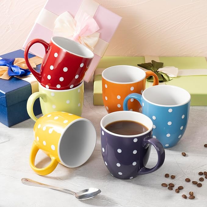 Colorful ceramic coffee mug set with red, yellow, orange, green, and blue polka-dot mugs.