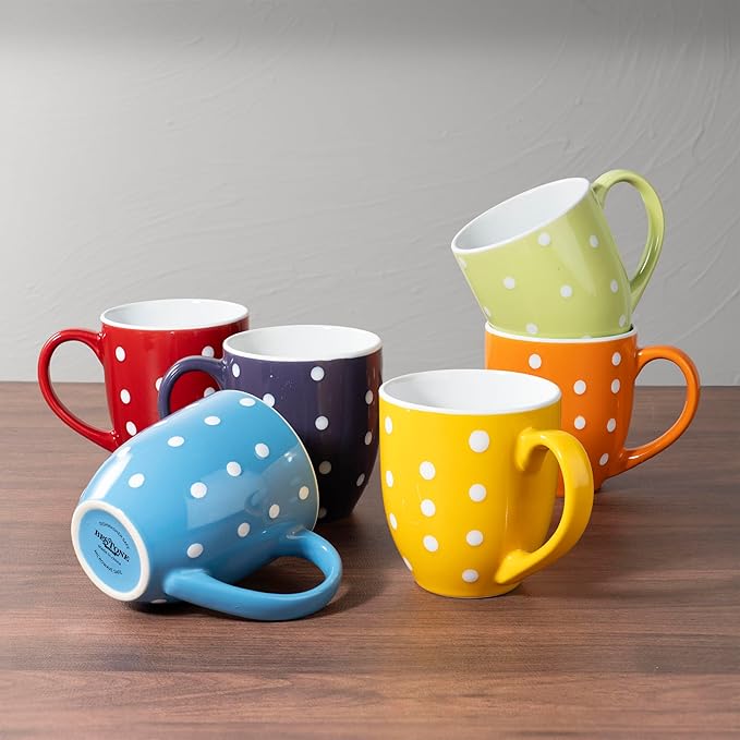 Ceramic polka-dot coffee mugs with handles in red, navy, yellow, blue, and green.
