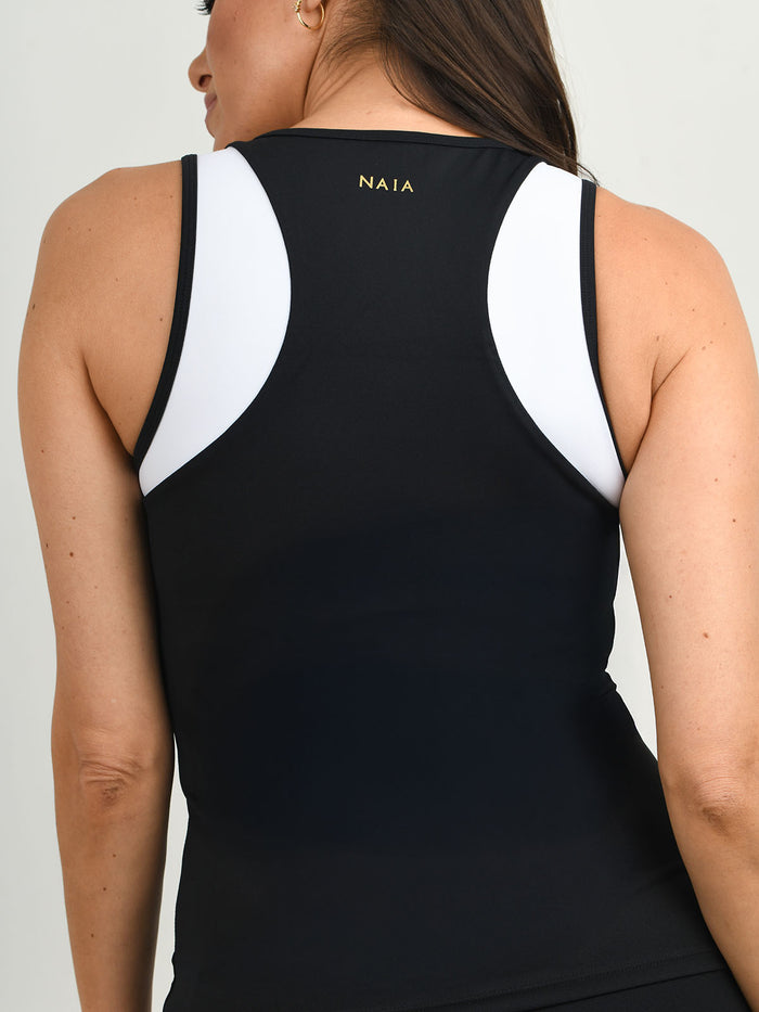 Billie Tipped vest worn with the Billie  legging in black with white piping detail from NAIA Active active wear collection