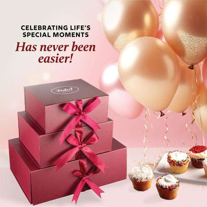 Birthday cupcakes and gift box with balloons for a celebration