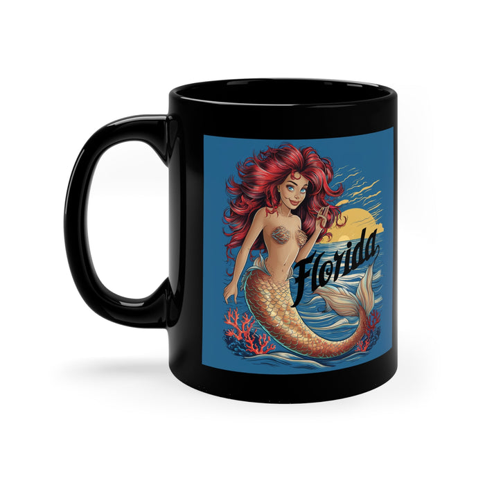 Black coffee mug with red-haired mermaid artwork and Florida script on front