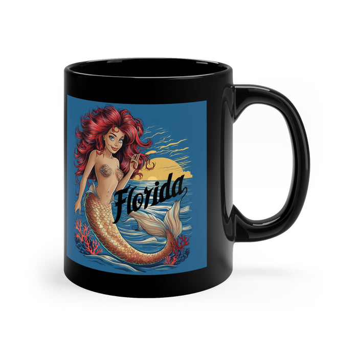 Black coffee mug with angled view of mermaid artwork and Florida script