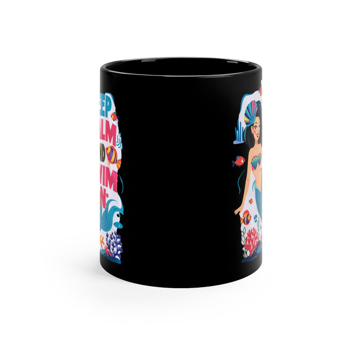 Black coffee mug with colorful mermaid graphic and “Keep Calm and Swim On” text
