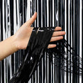 Black metallic fringe curtain panel, with long dangling strip ends